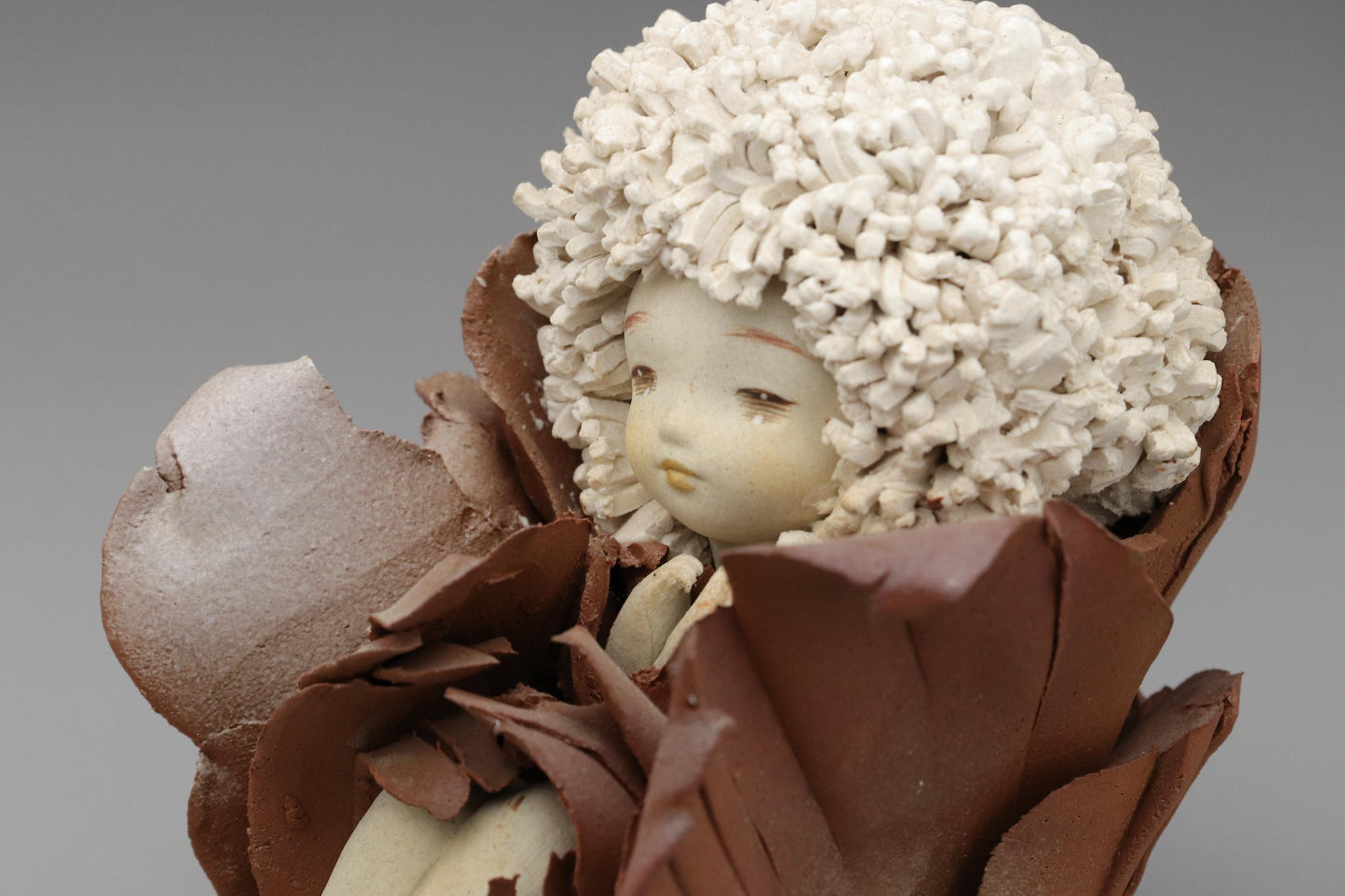 Ceramic Art Doll by Shoko Takeuchi Handcrafted Figurine With Curly Hair in Abstract Floral Form for Artistic Display or Interior Decoration